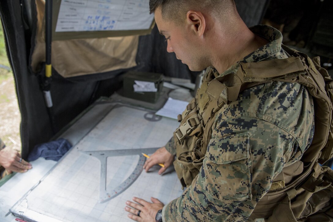 A Marine plots call-for-fire coordinates during a live-fire range at Camp Lejeune, N.C., July 26, 2017. The purpose of this field operation is to test and improve the unit’s capabilities by putting the Marines into a simulated combat environment. The Marine is with 1st Battalion, 10th Marine Regiment. (U.S. Marine Corps photo by Lance Cpl. Holly Pernell) 