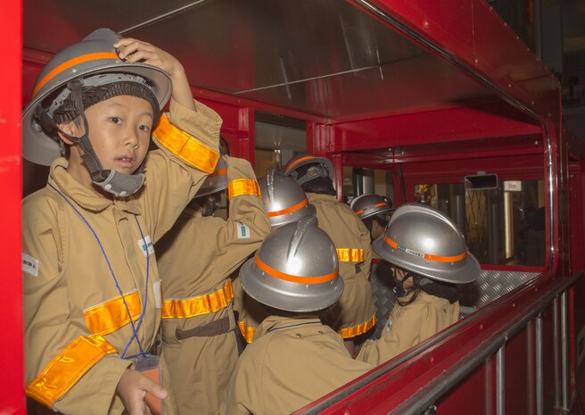 Japanese children role-play as firefighters during a trip to Kidzania in Kobe, Japan, July 26, 2017. Kidzania is themed as a child-sized replica of a real city including buildings, shops and theaters, as well as vehicles and pedestrians moving along its streets. Marine Corps Air Station Iwakuni residents visited the theme park as part of a Youth and Teen Center trip. (U.S. Marine Corps photo by Lance Cpl. Carlos Jimenez)