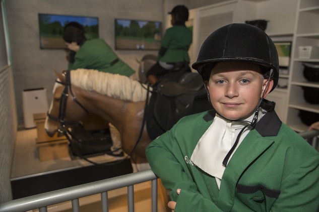 Travis Jordan, a Marine Corps Air Station Iwakuni residents, prepares mount a simulated horse ride during a trip with the Youth and Teen Center to Kidzania in Kobe, Japan, July 26, 2017. Complete with shops, vehicles, streets and street signs, Kidzania is a miniature city just for kids. Children are able to dress up and role-play as adults in nearly 100 jobs and activities with each profession offering the chance to use life-like tools and equipment. (U.S. Marine Corps photo by Lance Cpl. Carlos Jimenez)