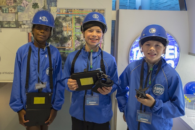From left to right, Ciera Roberts, Parker Staley and Carter Staley, Marine Corps Air Station Iwakuni residents, dress up as waterworks service workers during a trip with the Youth and Teen Center to Kidzania in Kobe, Japan, July 26, 2017. Kidzania is an indoor education entertainment center that provides children the interactive experience of working adult jobs and earning currency. Children are able to dress up and role-play as adults in nearly 100 jobs and activities with each profession offering the chance to use life-like tools and equipment. (U.S. Marine Corps photo by Lance Cpl. Carlos Jimenez)