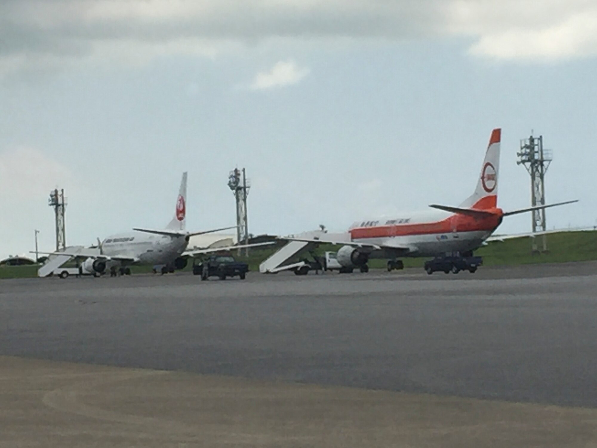 U.S. Airmen service two Japan Airlines Boeing 737 passenger aircraft July 26, 2017, at Kadena Air Base, Japan. The aircraft diverted to Kadena due to an aircraft malfunction-related runway closure at Naha Airport. (U.S. Air Force photo by Master Sgt. Dustin Troyer)