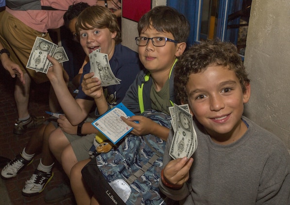 Youth and Teen Center members from Marine Corps Air Station Iwakuni hold up Kidzos, a special currency used in the theme park Kidzania in Kobe, Japan, July 26, 2017. Kidzania is an indoor education entertainment center that provides children the interactive experience of working adult jobs and earning currency. The currency can be spent on activities and used to buy souvenirs from gift shops. (U.S. Marine Corps photo by Lance Cpl. Carlos Jimenez)