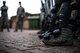 U.S. Airmen assigned to the 86th Security Forces Squadron hold their position during confrontational management training at the 86th SFS training section on Ramstein Air Base, Germany, July 25, 2017. Security forces use shin guards to protect themselves from thrown projectiles as well as crowds attempting to push through the line. (U.S. Air Force photo by Senior Airman Devin Boyer)