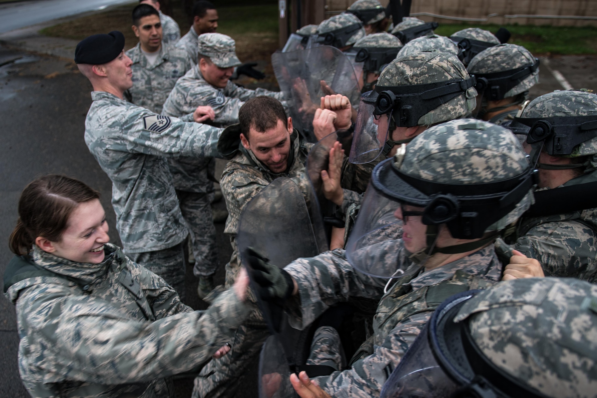 U.S. Airmen assigned to the 86th Security Forces Squadron hold their position during confrontational management training at the 86th SFS training section on Ramstein Air Base, Germany, July 25, 2017. At the end of their training, the security forces members had to use the techniques they learned to keep individuals from getting through their line of defense. (U.S. Air Force photo by Senior Airman Devin Boyer)
