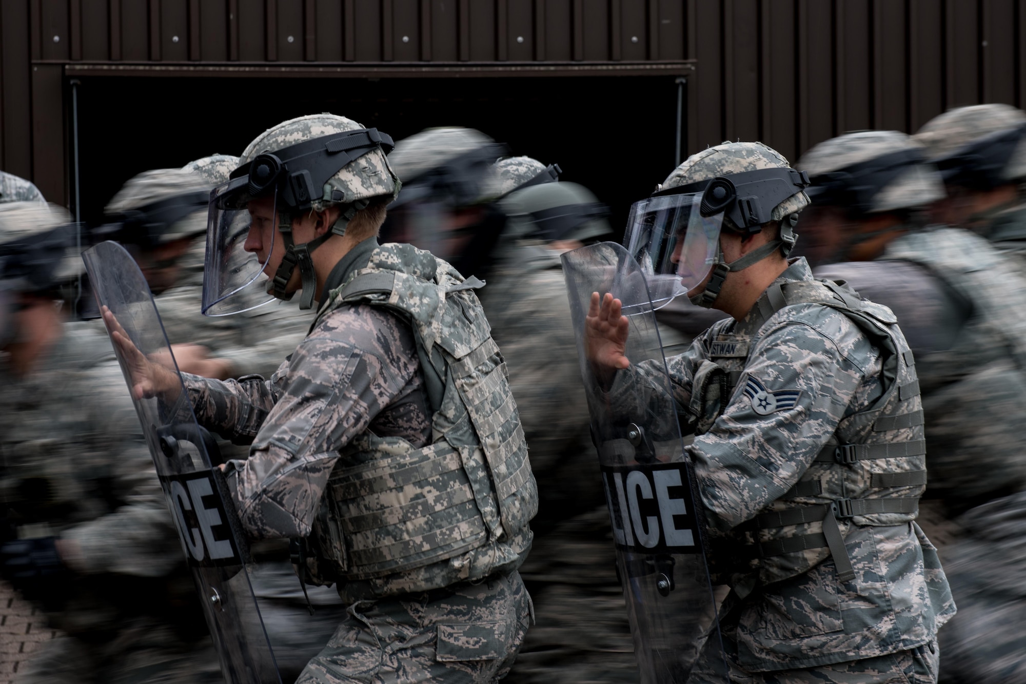 U.S. Airmen assigned to the 86th Security Forces Squadron perform formation maneuvers during confrontational management training at the 86th SFS training section on Ramstein Air Base, Germany, July 25, 2017. The formation they practiced allowed them to keep their defenses while others moved forward to detain rioters. (U.S. Air Force photo by Senior Airman Devin Boyer)