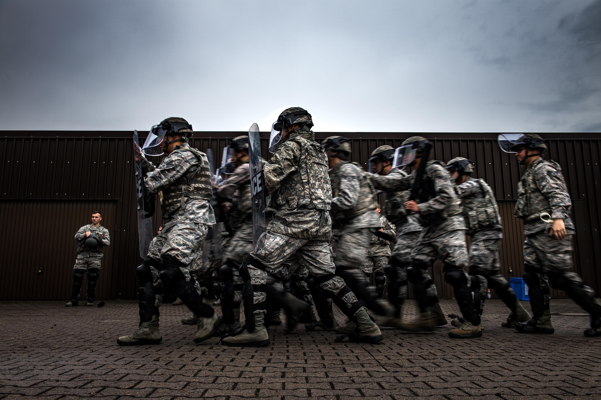 U.S. Airmen assigned to the 86th Security Forces Squadron perform formation maneuvers during confrontational management training at the 86th SFS training section on Ramstein Air Base, Germany, July 25, 2017. The security forces Airmen practiced formations repeatedly until they felt confident doing them in a real world event. (U.S. Air Force photo by Senior Airman Devin Boyer)