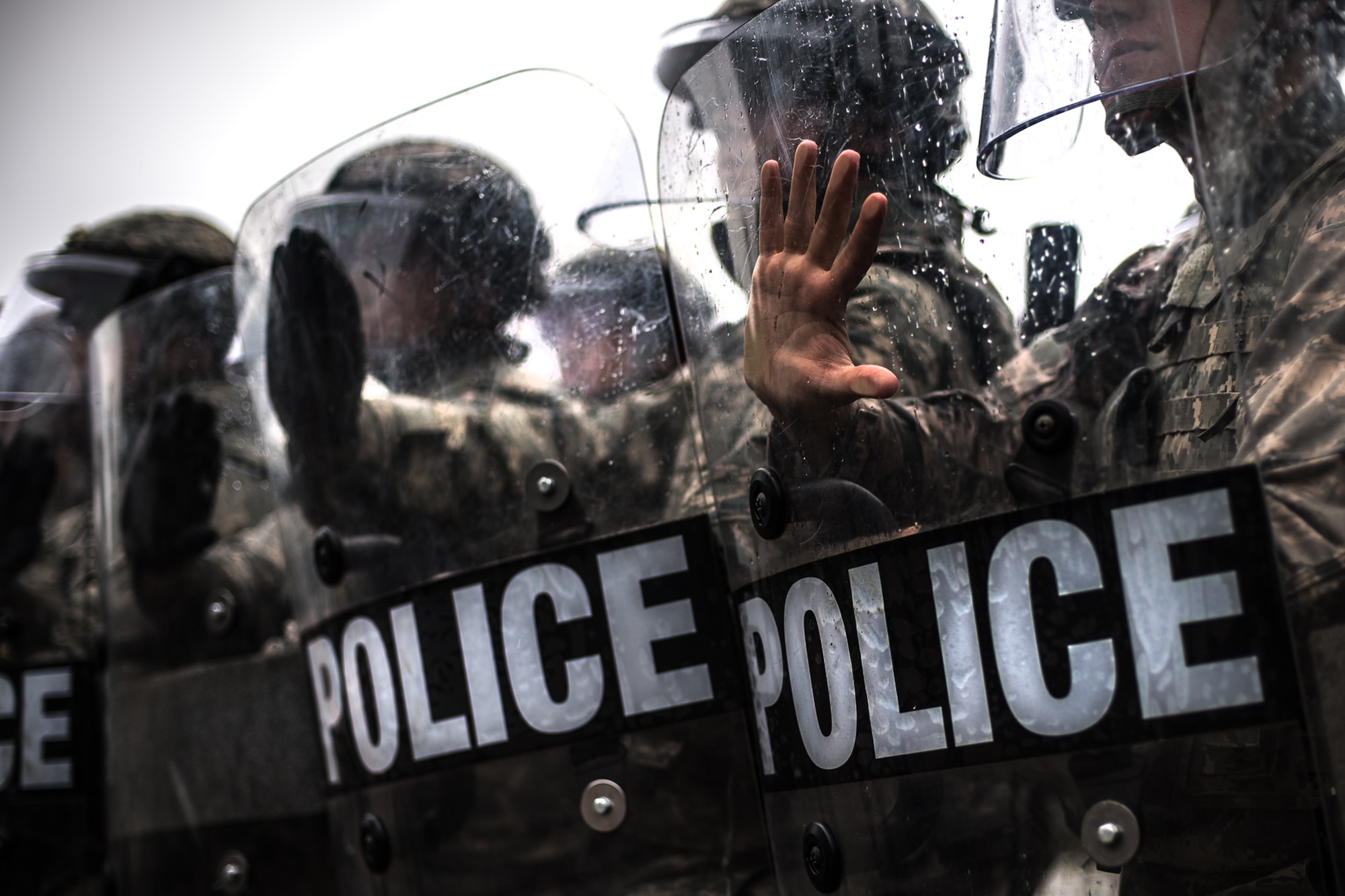 U.S. Airmen assigned to the 86th Security Forces Squadron hold their position during confrontational management training at the 86th SFS training section on Ramstein Air Base, Germany, July 25, 2017. The equipment they use protects them from thrown projectiles such as bottles or debris. They can also use the shields as short-ranged melee weapons to push back rioters. (U.S. Air Force photo by Senior Airman Devin Boyer)