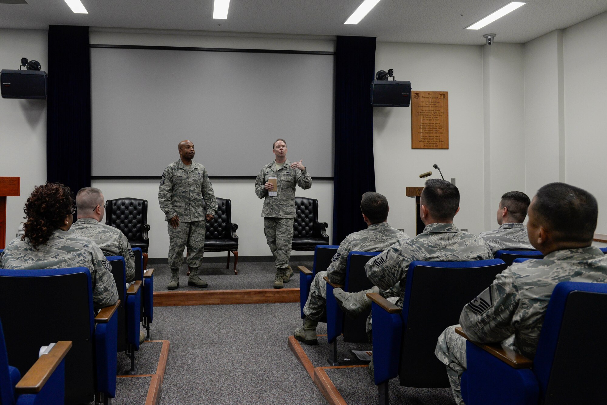 Col. John Winkler, 374th Mission Support Group commander, right, and Chief Master Sgt. Elvin Young, 374th Airlift Wing command chief, left, addresses the attendees of the annual First Sergeant Symposium, July 27, 2017, at Yokota Air Base, Japan. Winkler and Young spoke to the importance of the role of being a first sergeant. The four day course consisted of academics provided by the U.S. Air Force First Sergeants Academy for senior NCOs with the knowledge to better serve commanders on issues impacting Airmen.