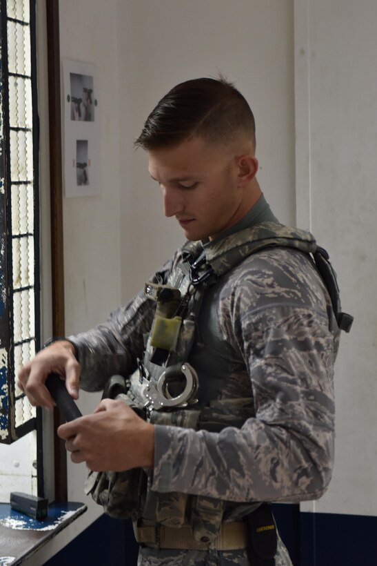 Tech. Sgt. Richard, member of the 380th Expeditionary Security Forces Squadron,  inspects a baton upon issue at Al Dhafra Air Base,  United Arab Emirates,  July 25,  2017. Members confirm that all issued weapons are in serviceable condition upon issue so that they are prepared to defend the base from any threat. (U.S. Air Force photo by Staff Sgt. Marjorie A. Bowlden)