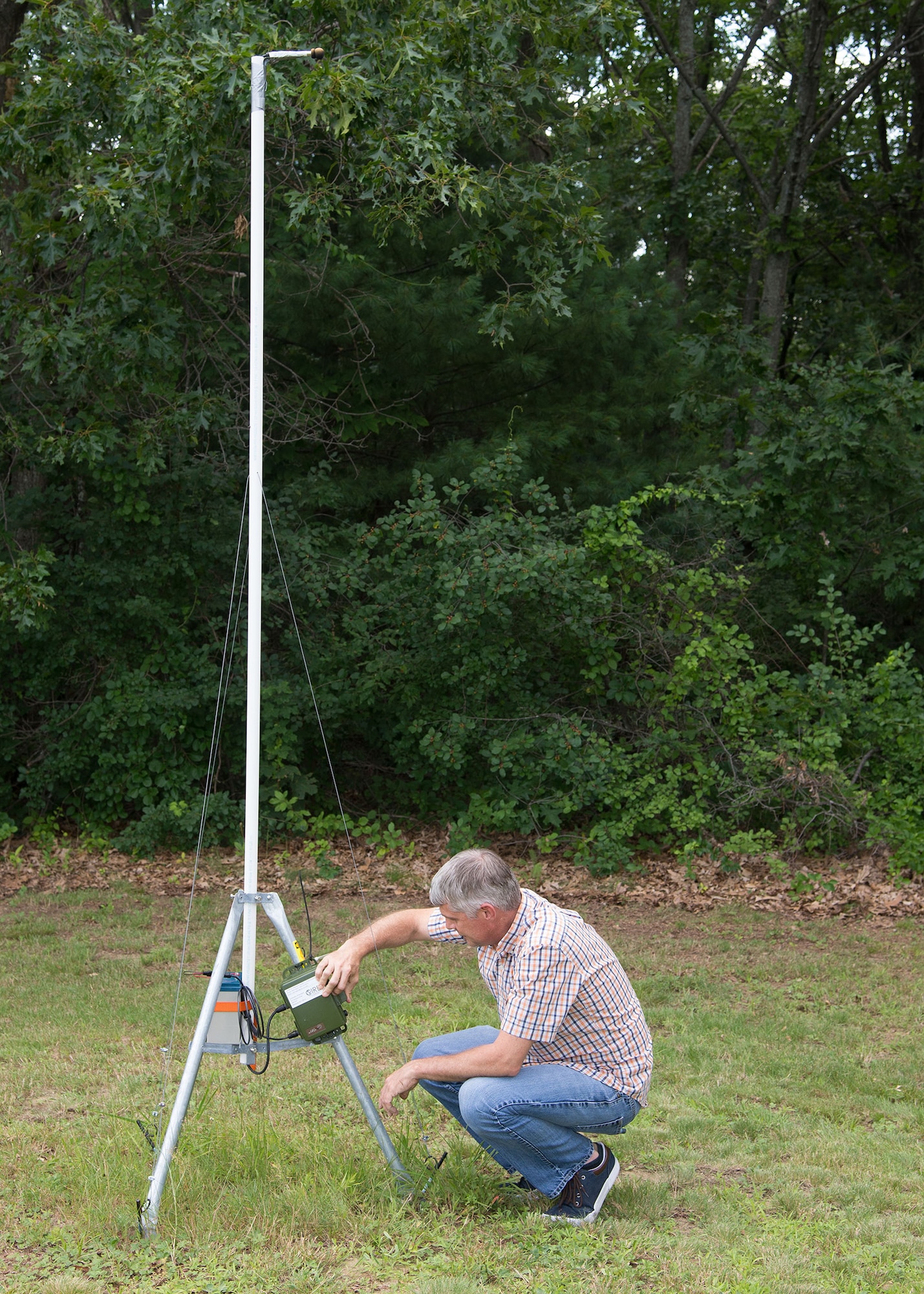 Scott Sheehan, 66th Civil Engineering Division environmental engineer, inspects a bat monitor located at Hanscom Air Force Base, Mass., July 26. Members of the 66th Civil Engineering Division Environmental Office are assisting the Air Force Civil Engineer Center with a 90-day bat species diversity survey on the base. (U.S. Air Force photo by Mark Herlihy)