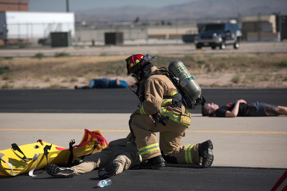 An exercise participant evaluates a mock casualty during a major accident response training event at Gowen Field in Boise, Idaho, July 21, 2017. Air National Guard photo by Tech. Sgt. John Winn