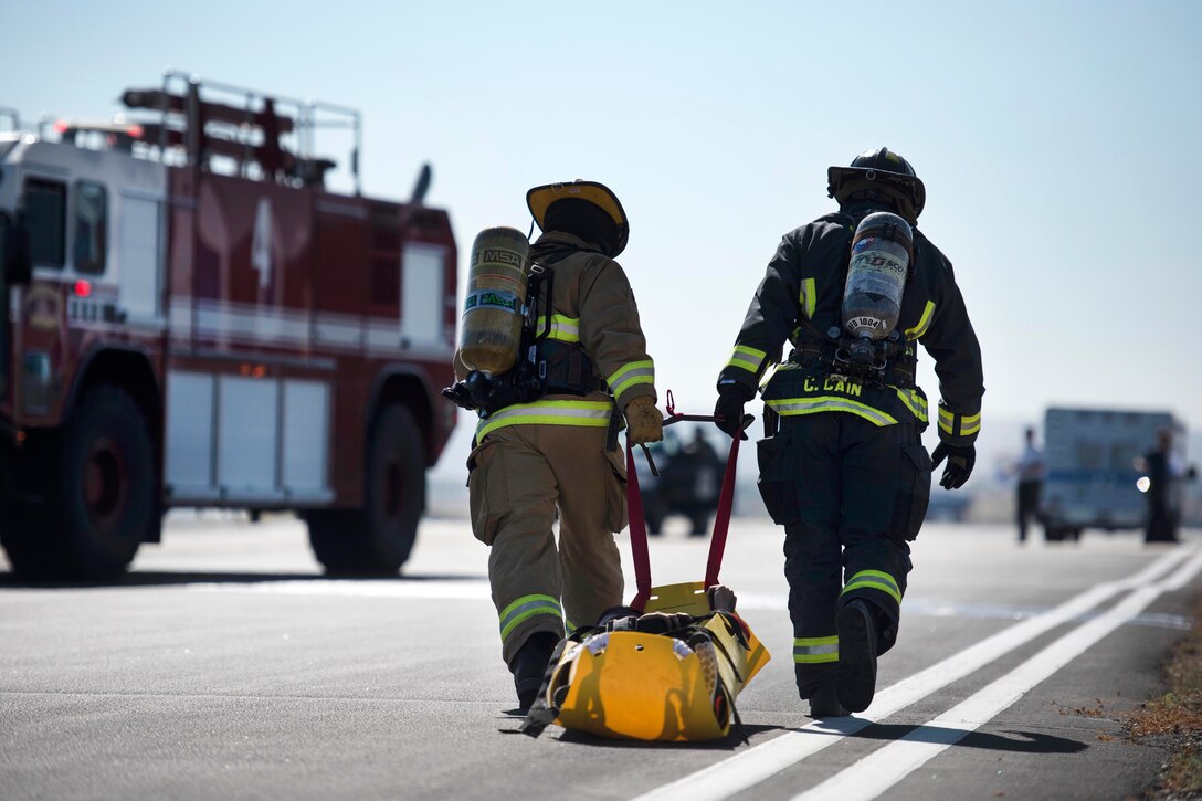 Exercise participants drag a mock casualty during a major accident response training event at Gowen Field in Boise, Idaho, July 21, 2017. Air National Guard photo by Tech. Sgt. John Winn