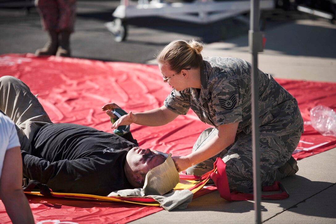 An Idaho Air National Guardsman provides medical care to a mock casualty during a major accident response exercise at Gowen Field in Boise, Idaho, July 21, 2017. Air National Guard photo by Tech. Sgt. John Winn