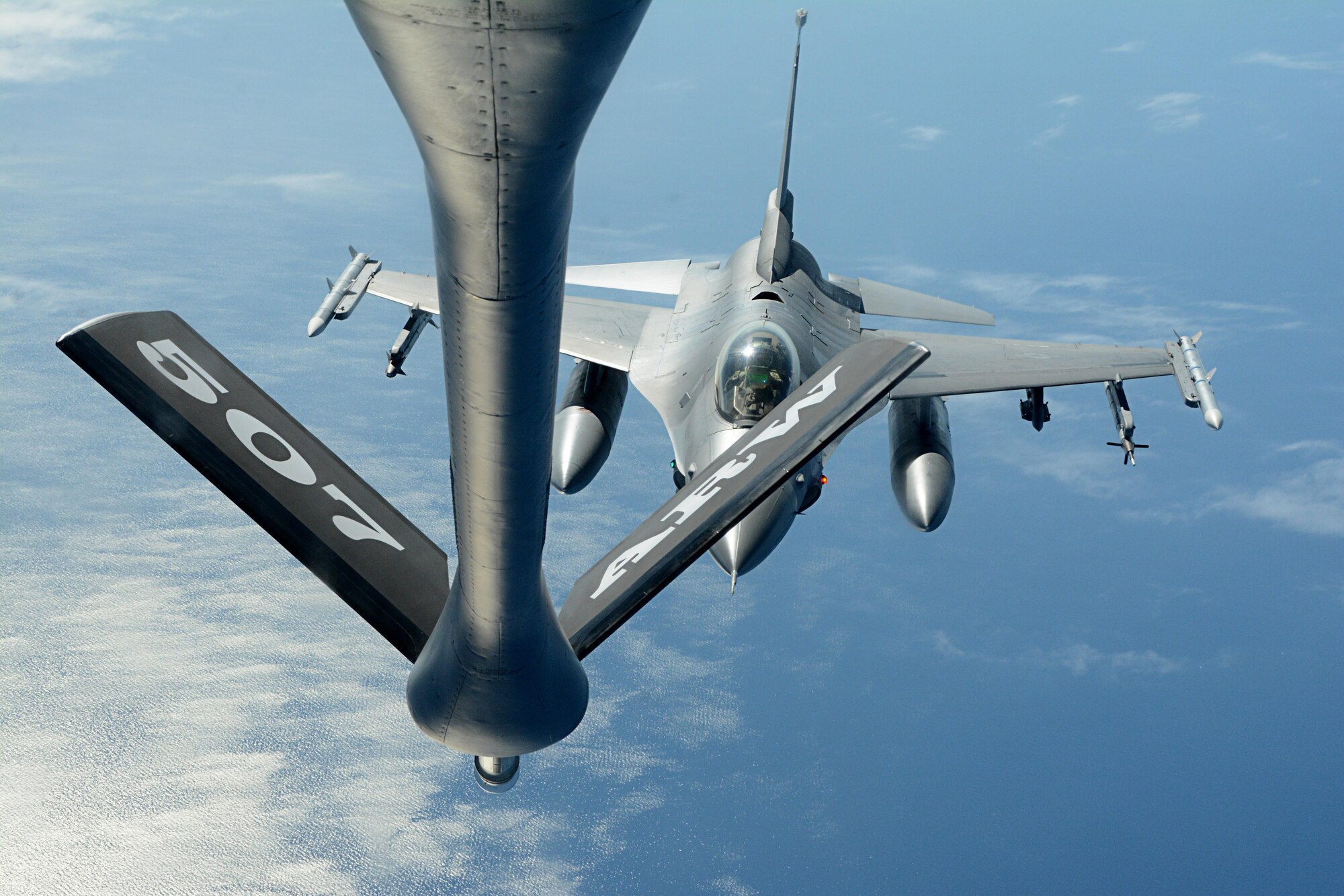 Reserve Citizen Airmen from the 465th Air Refueling Squadron at Tinker Air Force Base, Okla., deliver fuel to an F-16 Fighting Falcon from Spangdahlem Air Base, Germany, July 25, 2017. In a long-standing partnership between the Air Force Reserve Command and U.S. Air Forces in Europe, members of the 507th Air Refueling Wing are augmenting the 100th Air Refueling Wing July 1-29, 2017, to provide KC-135R air refueling support to the European theater of operations. (U.S. Air Force photo/Tech Sgt. Lauren Gleason)