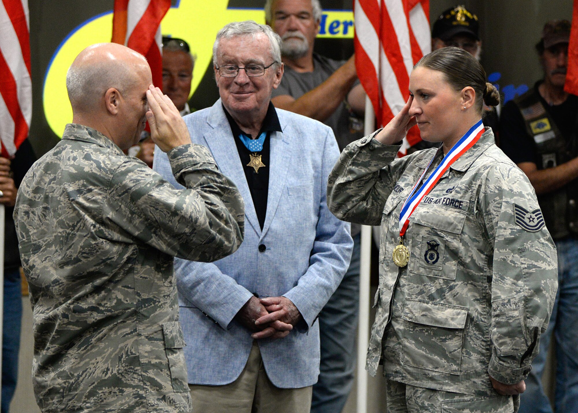 Tech. Sgt. Michelle Armour, a member of the 66th Security Forces Squadron, returns a salute from Col. Roman L. Hund, installation commander, during the Hanscom Heroes Homecoming event at Hanscom Air Force Base, Mass., July 27. Airmen who have returned home from deployment in the past year, along with family members, were honored during the ceremony. (U.S Air Force photo by Mark Herlihy)