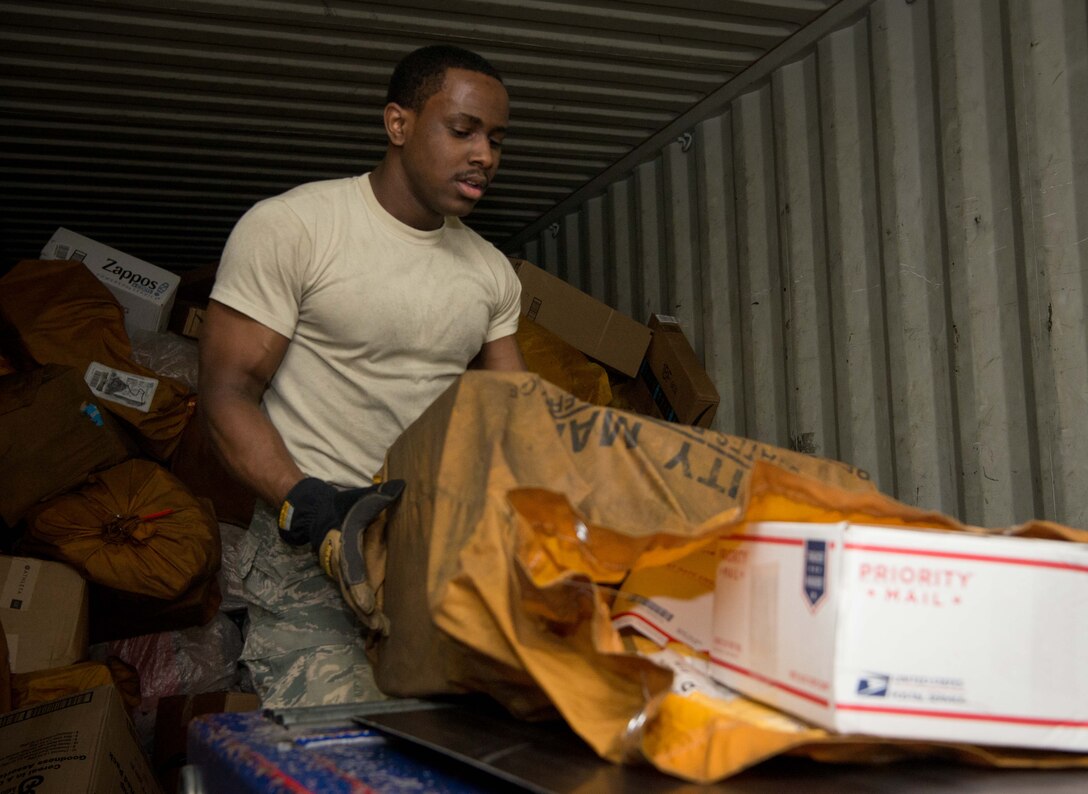 U.S. Air Force Senior Airman Cedric Patterson, 86th Mission Support Group Communications Squadron North Side Post Office postal specialist, unloads packages on Ramstein Air Base, Germany, July 27, 2017. The North Side Post Office has handled 338,000 pieces so far this year, delivering morale to the Kaiserslautern Military Community and serving as a link between Germany and “home.” (U.S. Air Force photo by Senior Airman Elizabeth Baker)