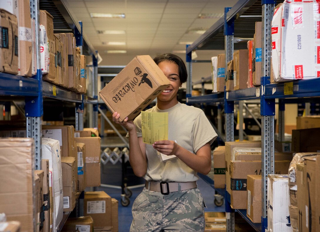 U.S. Air Force Airman 1st Class Sheyenne Cox, 86th Mission Support Group Communications Squadron North Side Post Office postal specialist, carries a package to a customer on Ramstein Air Base, Germany, July 27, 2017. The North Side Post Office received and sorted a million pounds of parcels and envelopes last year with the intention of helping military families feel closer to home. (U.S. Air Force photo by Senior Airman Elizabeth Baker)