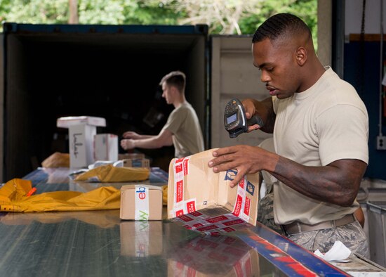 U.S. Air Force Staff Sgt. Shaun Roberts, 86th Mission Support Group Communications Squadron North Side Post Office section lead, scans a package on Ramstein Air Base, Germany, July 27, 2017. The North Side Post Office, the largest post office in the Department of Defense, employs 53 Airmen to support the morale of roughly 30,000 personnel and families by giving them a convenient way to receive packages from home and abroad. (U.S. Air Force photo by Senior Airman Elizabeth Baker)