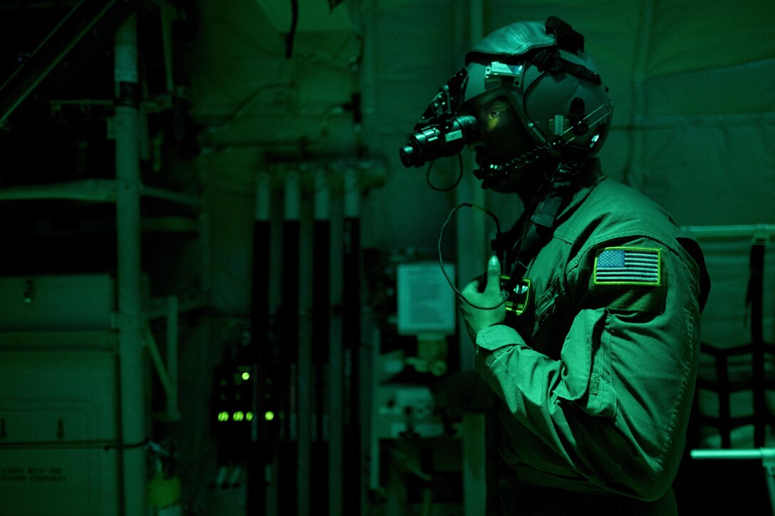 Airman 1st Class Young Achuka, a 36th Airlift Squadron C-130J Super Hercules loadmaster, communicates with aircrew during cargo drop training, July 18, 2017, at Yokota Air Base, Japan. Regular night time training operations are essential and ensure 24-hour mission readiness. (U.S. Air Force photo/Airman 1st Class Donald Hudson)