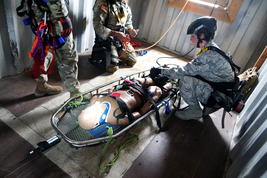 An airman loads a mock casualty onto a stretcher and prepares for a high angle rescue out of a window during a combined training exercise in Kalaeloa, Hawaii, July 19, 2017. The airman is assigned to the Hawaii Air National Guard’s Medical Detachment 1. Air National Guard photo by Tech. Sgt. Andrew Jackson