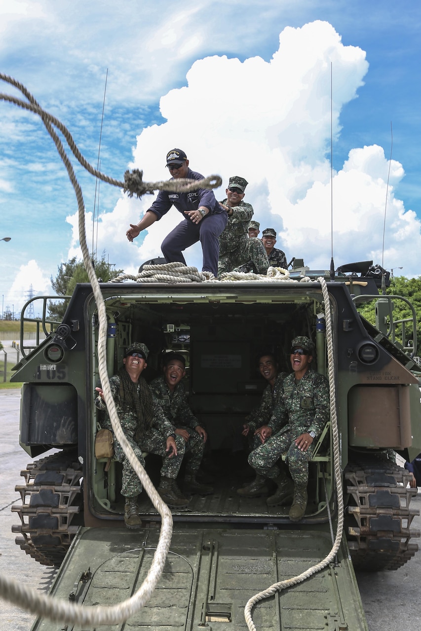 Philippine Marines with Assault Armor Battalion practice tossing a rope from one amphibious assault vehicle to another during egress training at Camp Schwab, Okinawa, Japan, July 18, 2017. This was the first time the Philippine military conducted training at an American base. The Philippine Marine Corps recently purchased AAVS and were working with U.S. Marines to learn different amphibious procedures -- such as hand signaling, egress training and water operations. Marine Corps photo by Lance Cpl. Jordan A. Talley