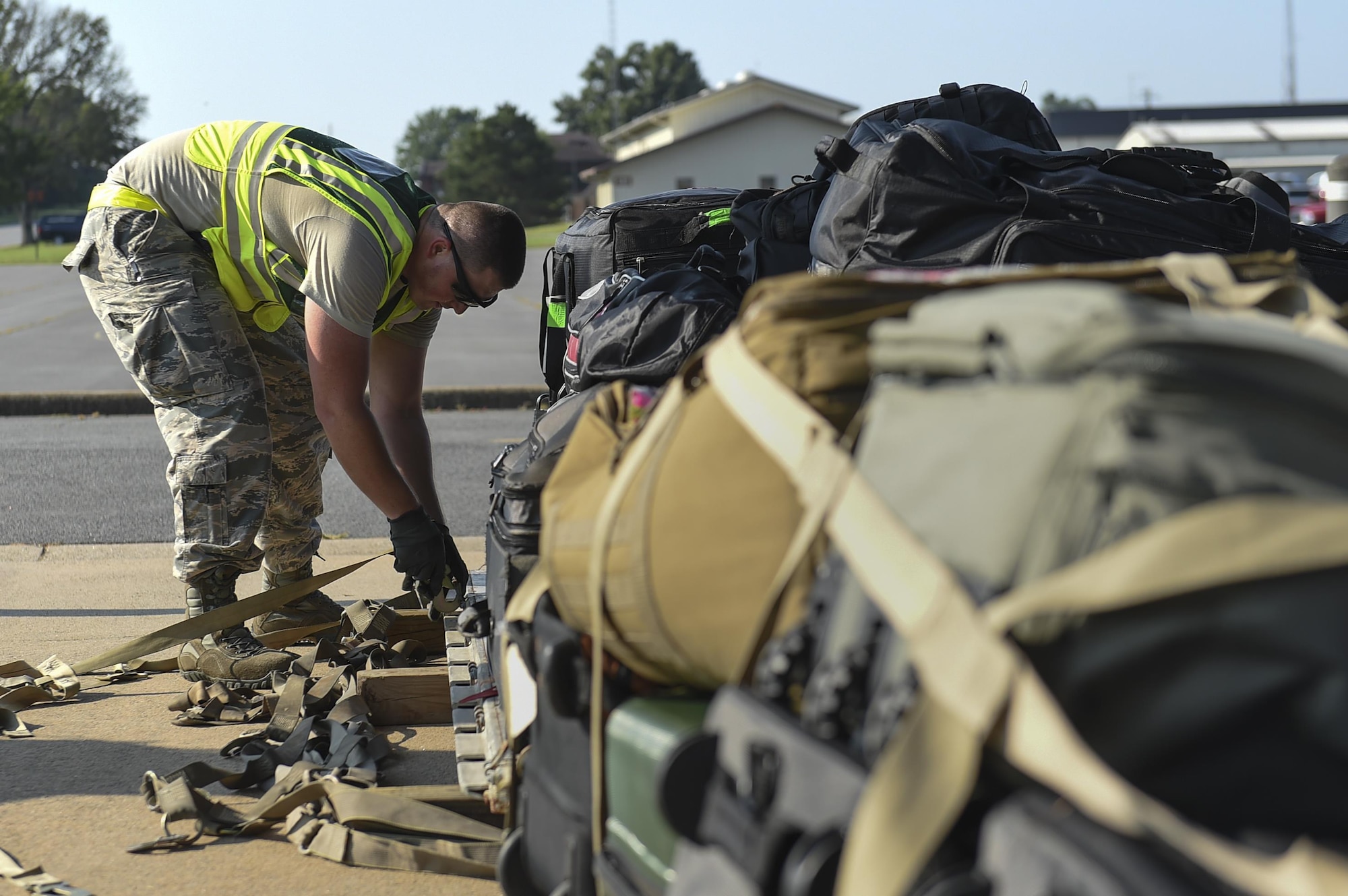 Senior Airman Troy Iversen, 19th Logistics Readiness Squadron aerial delivery rigger, secures baggage cargo onto a pallet July 20, 2017, at Little Rock Air Force Base, Ark. More than 3,000 Air Mobility Command Airmen will travel to Washington in order to participate in Mobility Guardian 2017, a massive exercise testing airlift and airdrop capabilities alongside 25 international partners. (U.S. Air Force photo by Staff Sgt. Harry Brexel)