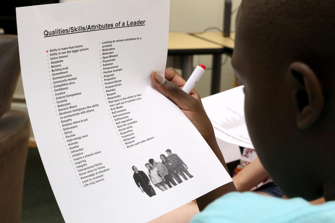Trevor, 13, reads over a leader qualities checklist during a Stand Out Leaders in Training teen leadership day aboard Marine Corps Air Station Cherry Point, N.C., July 25, 2017. The day started with a guided discussion titled Leadership 101 to identify what traits the students have and can build upon. Trevor is a high school student in Craven County. (U.S. Marine Corps photo by Cpl. Jason Jimenez/ Released)