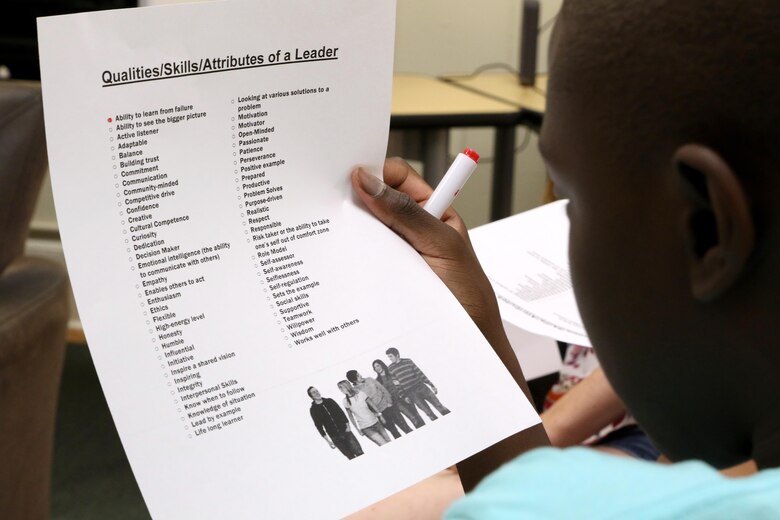 Trevor, 13, reads over a leader qualities checklist during a Stand Out Leaders in Training teen leadership day aboard Marine Corps Air Station Cherry Point, N.C., July 25, 2017. The day started with a guided discussion titled Leadership 101 to identify what traits the students have and can build upon. Trevor is a high school student in Craven County. (U.S. Marine Corps photo by Cpl. Jason Jimenez/ Released)