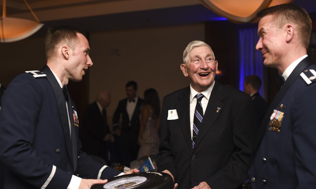 Richard McCormick, World War II veteran, receives a clock from the 457th Airlift Squadron leadership during the squadron’s 75th anniversary banquet at Joint Base Andrews, Md., June 30, 2017. McCormick was a central fire control operator with the 457th Bombardment Squadron stationed in the Pacific during WWII.  (U.S. Air Force photo by Airman 1st Class Rustie Kramer)