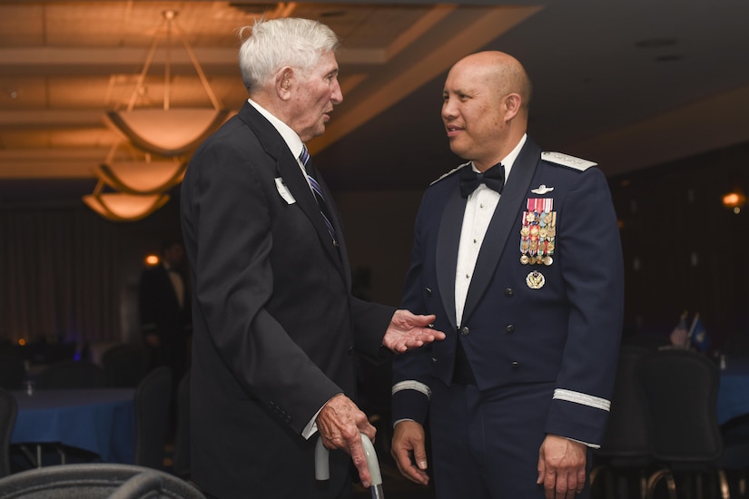 Richard McCormick, World War II veteran, speaks to Lt. Gen. Giovanni Tuck, 18th Air Force commander, at the 457th Airlift Squadron’s 75th anniversary banquet at Joint Base Andrews, Md., June 30, 2017. McCormick was a central fire control operator with the 457th Bombardment Squadron stationed in the Pacific during WWII.  (U.S. Air Force photo by Airman 1st Class Rustie Kramer) 