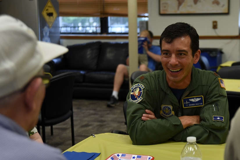 Maj. Shawn Hooton, 357th Operations Group pilot, listens to the stories of World War II veteran Richard McCormick during a tour of the 457th Airlift Squadron at Joint Base Andrews, Md., June 30, 2017. McCormick was a central fire control operator with the 457th Bombardment Squadron stationed in the Pacific during WWII.  The tour was part of the 457th AS’s 75th anniversary celebration.  (U.S. Air Force by Airman 1st Class Rustie Kramer) 