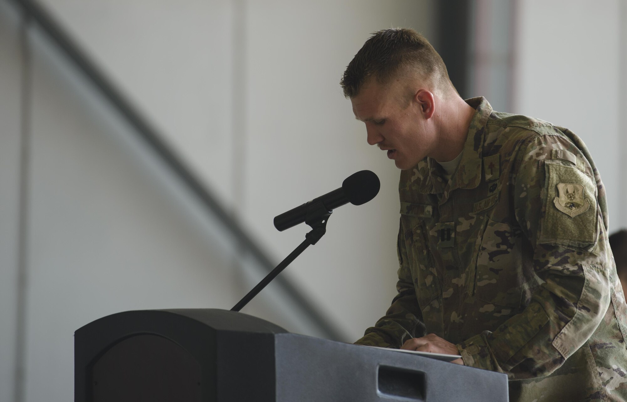 Chaplain (Capt.) Joshua Flynn, 455th Air Expeditionary Wing, delivers an invocation during a ceremony at Bagram Airfield, Afghanistan, July 14, 2017. Religious support teams from the 455th AEW travel throughout Afghanistan to accommodate the spiritual needs of service members and coalition forces. (U.S. Air Force photo by Staff Sgt. Benjamin Gonsier)