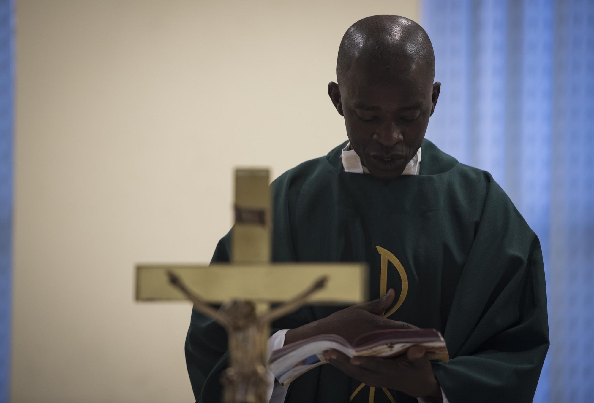 Chaplain (Capt.) John Appiah, 455th Air Expeditionary Wing, recites a passage during a religious service at Hamid Karzai International Airport, Kabul, Afghanistan, July 23, 2017. Religious support teams from Bagram Airfield visit six different locations in Afghanistan where a chaplain is not deployed. (U.S. Air Force photo by Staff Sgt. Benjamin Gonsier)