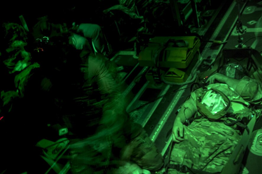 A 38th Rescue Squadron pararescueman assesses a patient's wounds during a simulated training, June 21, 2017, at Moody Air Force Base, Ga. The Air Force Research Laboratory from Wright-Patterson Air Force Base, Ohio and the Baltimore U.S. Air Force Center for Sustainment of Trauma and Readiness Skills, observed Moody's Combat Search and Rescue aeromedical patient processes and survival kit technology, in hopes of reducing risks to improve the overall Air Force mission. (U.S. Air Force photo by Staff Sgt. Ryan Callaghan) 