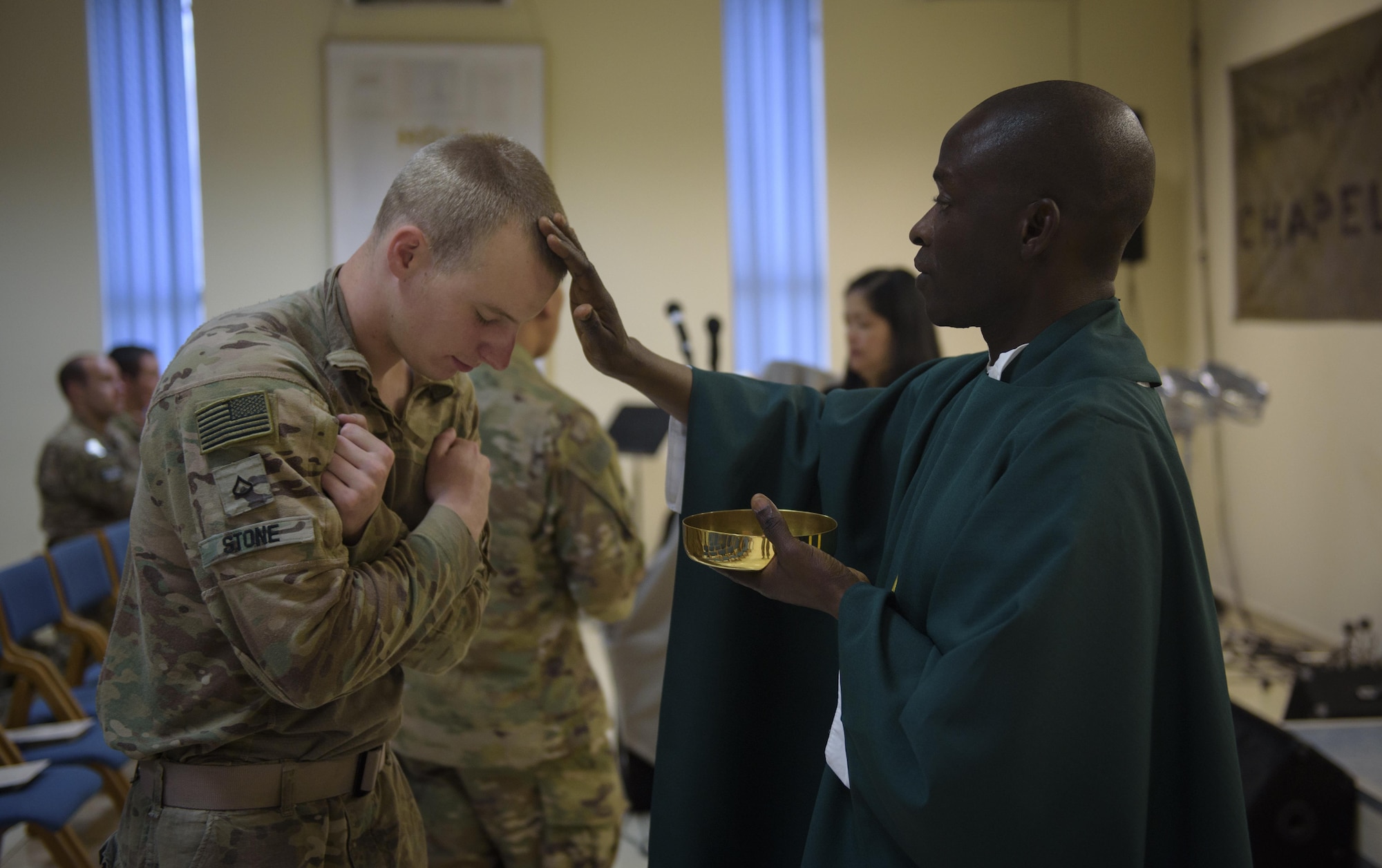 Chaplain (Capt.) John Appiah, 455th Air Expeditionary Wing, blesses a U.S. Army Soldier during a religious service at Hamid Karzai International Airport, Kabul, Afghanistan, July 23, 2017. Religious support teams from Bagram Airfield visit six different locations in Afghanistan where a chaplain is not deployed. (U.S. Air Force photo by Staff Sgt. Benjamin Gonsier) 