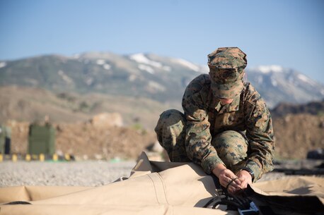 U.S. Marine Pfc.Olivia Rutherford, an ammunition technician with Combat Logistics Battalion 5 (CLB-5), Combat Logistics Regiment 1, 1st Marine Logistics Group, helps tie a knot on an expeditionary mess hall during a Mountain Exercise 4-17 on the Marine Corps Mountain Warfare Training Center Bridgeport, Calif., June 14, 2017. CLB-5 supports the 2d Battalion, 8th Marine Regiment, 2d Marine Division, logistically by tackling the technical aspects of mountainous and cold weather operations by providing them chow, water, and fuel. (U.S. Marine Corps photo by Lance Cpl. Timothy Shoemaker)