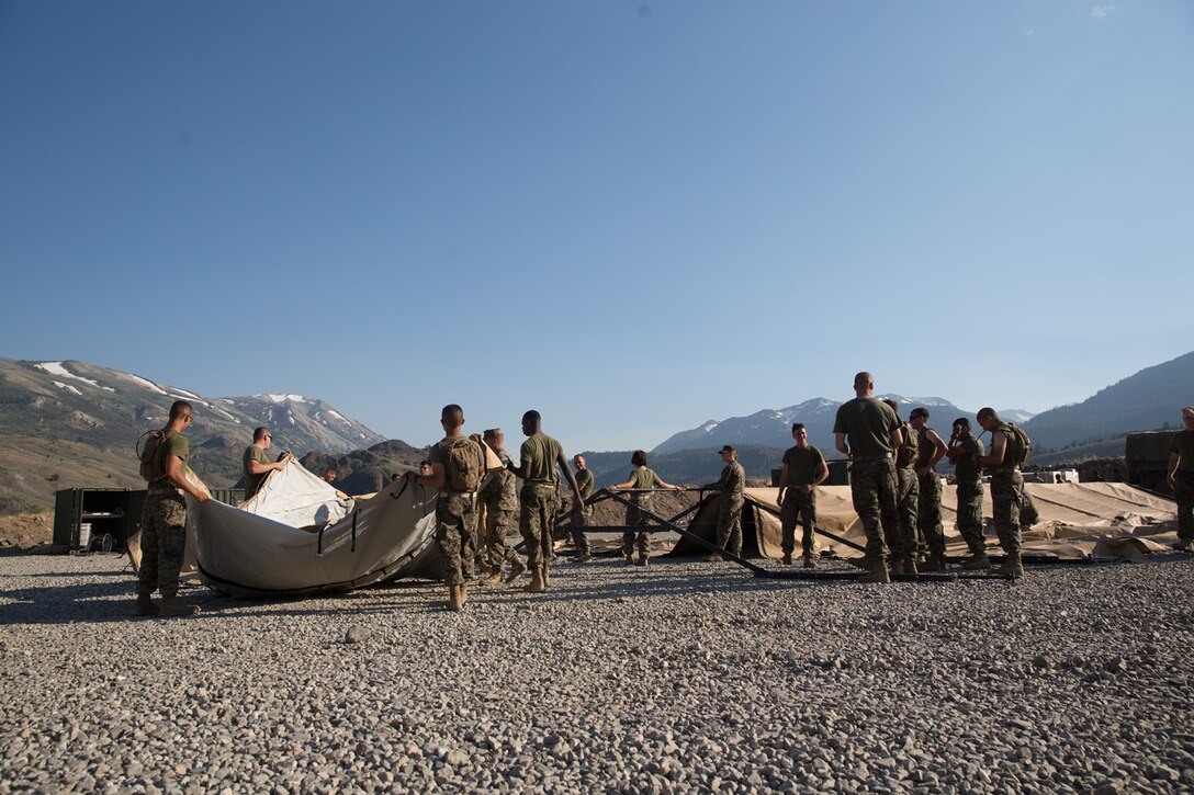 U.S. Marines with Combat Logistics Battalion 5 (CLB-5), Combat Logistics Regiment 1, 1st Marine Logistics Group, begin the construction of an expeditionary mess hall on the Marine Corps Mountain Warfare Training Center Bridgeport, Calif., June 14, 2017. CLB-5 supports the 2d Battalion, 8th Marine Regiment, 2d Marine Division, logistically by tackling the technical aspects of mountainous and cold weather operations by providing them chow, water, and fuel. (U.S. Marine Corps photo by Lance Cpl. Timothy Shoemaker)