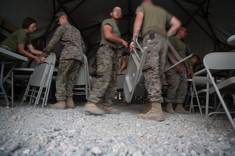 U.S. Marines with Combat Logistics Battalion 5 (CLB-5), Combat Logistics Regiment 1, 1st Marine Logistics Group, place chairs inside an expeditionary mess hall on the Marine Corps Mountain Warfare Training Center Bridgeport, Calif., June 14, 2017. CLB-5 supports the 2d Battalion, 8th Marine Regiment, 2d Marine Division, logistically by tackling the technical aspects of mountainous and cold weather operations by providing them chow, water, and fuel. (U.S. Marine Corps photo by Lance Cpl. Timothy Shoemaker)