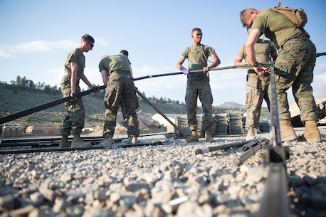 U.S. Marines with Combat Logistics Battalion 5 (CLB-5), Combat Logistics Regiment 1, 1st Marine Logistics Group, help form the foundation of an expeditionary mess hall tent on the Marine Corps Mountain Warfare Training Center Bridgeport, Calif., June 14, 2017. CLB-5 supports the 2d Battalion, 8th Marine Regiment, 2d Marine Division, logistically by tackling the technical aspects of mountainous and cold weather operations by providing them chow, water, and fuel. (U.S. Marine Corps photo by Lance Cpl. Timothy Shoemaker)