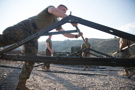 U.S. Marines with Combat Logistics Battalion 5 (CLB-5), Combat Logistics Regiment 1, 1st Marine Logistics Group, help form the foundation of an expeditionary mess hall on the Marine Corps Mountain Warfare Training Center Bridgeport, Calif., June 14, 2017. CLB-5 supports the 2d Battalion, 8th Marine Regiment, 2d Marine Division, logistically by tackling the technical aspects of mountainous and cold weather operations by providing them chow, water, and fuel. (U.S. Marine Corps photo by Lance Cpl. Timothy Shoemaker)