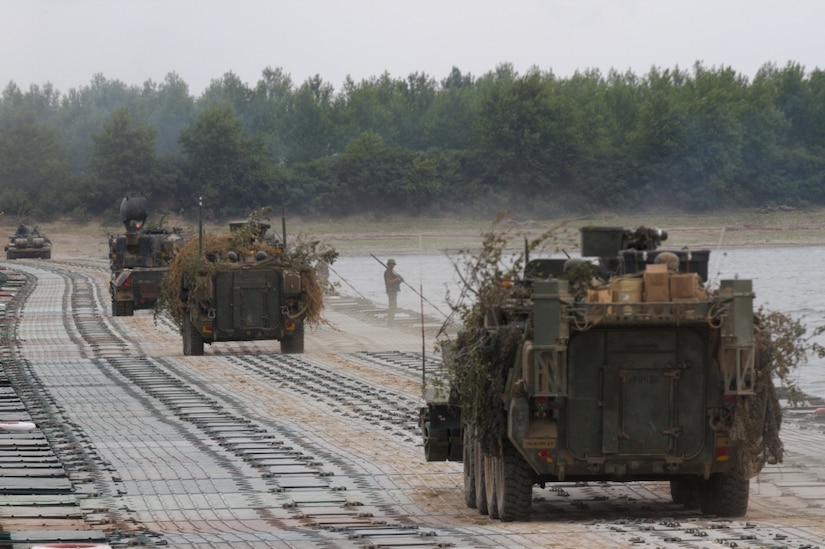 Army M1126 Stryker combat vehicles drive across a floating bridge during a river crossing exercise at Bordusani, Romania, July 16, 2017. The combined exercise was one of the major events of Saber Guardian 2017. Army photo by Pfc. Nicholas Vidro