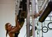 Brittany Reid, an Alpha Warrior professional, demonstrates how to complete the Alpha Warrior obstacle course at Whiteman Air Force Base, Mo., July 22, 2017. A permanent rig was set-up at the fitness center for the base populace to use and prepare for regionals.