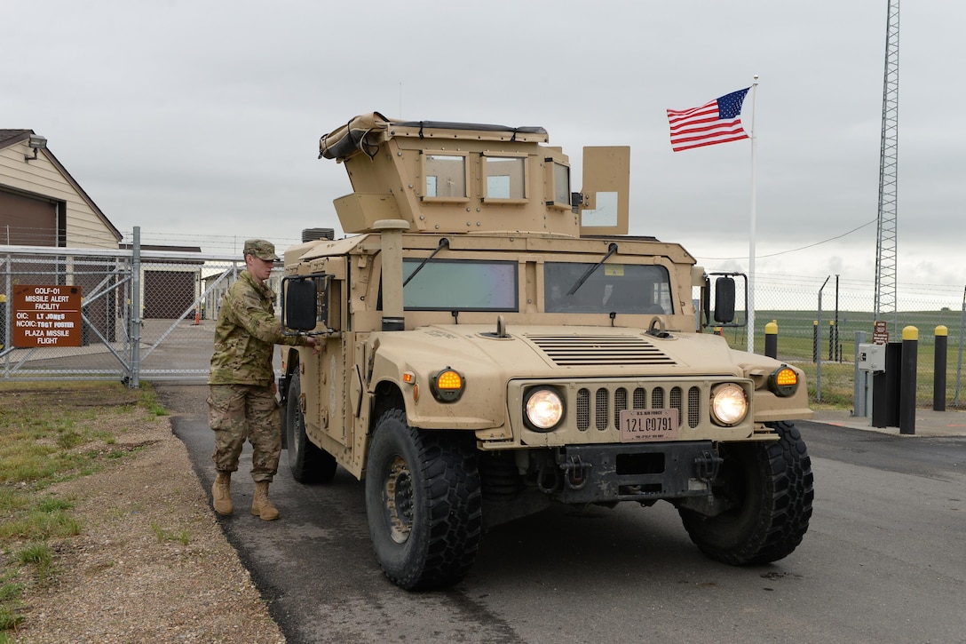 U.S. Air Force Senior Airman Tanner Hart, of the 219th Security Forces Squadron, opens the door to a High Mobility Multipurpose Wheeled Vehicle (HMMWV), commonly known as a Humvee, as he prepares to leave a missile alert facility in the Minot Air Force Base missile field complex, near Minot, N.D., June 15, 2017. He is a member of the North Dakota Air National Guard training and working seamlessly, side-by-side with U.S. Air Force active duty security forces members of the 91st Missile Wing as they maintain security standards in the missile fields. (U.S. Air National Guard Photo by Senior Master Sgt. David H. Lipp/Released)