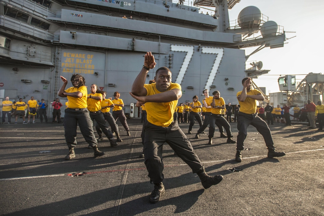 A step team performs before a suicide prevention and awareness 5K run aboard the aircraft carrier USS George H.W. Bush in the Mediterranean Sea, July 22, 2017. The ship and its carrier strike group are conducting naval operations in the U.S. 6th Fleet area of operations to support U.S. national security interests in Europe and Africa. Navy photo by Petty Officer 3rd Class Tristan B. Lotz