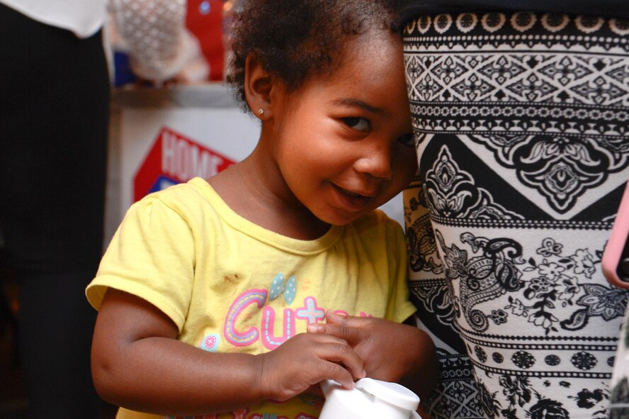 A girl embraces her mother at the Back to School Night hosted by the 2nd Force Support Squadron at Barksdale Air Force Base, La., July 24, 2017. School of Choice is an initiative that allows families to choose the best school for their children from kindergarten through 12th grade. (U.S. Air Force Photo/Airman 1st Class Sydney Bennett)