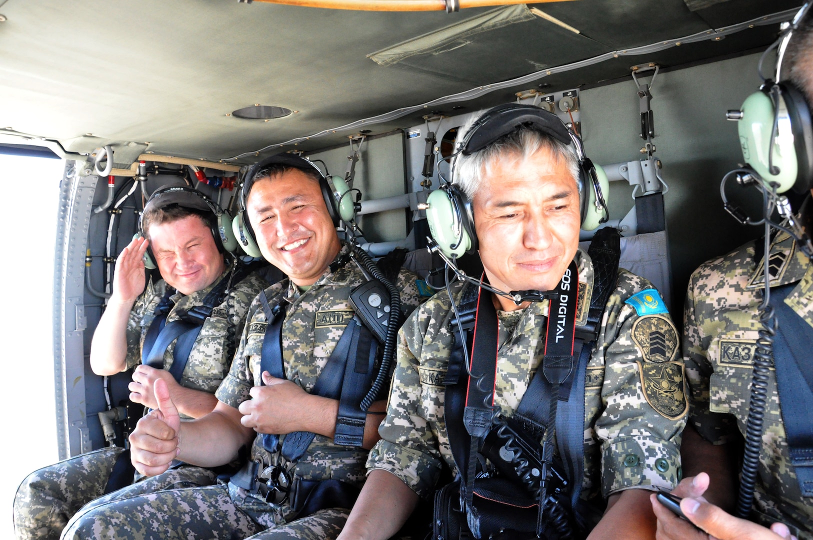 Noncommissioned officers from the Armed Forces of the Republic of Kazakhstan enjoy a UH-60 Black Hawk flight over Arizona, Sep. 11, 2014. A delegation of Kazakhs met with Arizona Army and Air Guard members to discuss the varied roles of enlisted members in military aviation. Kazakhstan and the Arizona National Guard have participated together in the National Guard Bureau’s State Partnership Program since 1993. (National Guard photo by Spc. Wes Parrell)