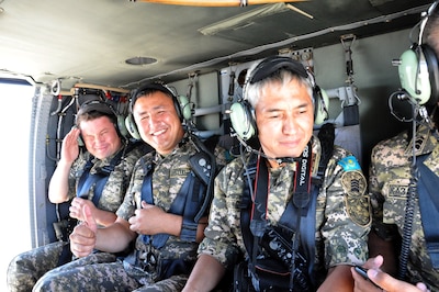 Noncommissioned officers from the Armed Forces of the Republic of Kazakhstan enjoy a UH-60 Black Hawk flight over Arizona, Sep. 11, 2014. A delegation of Kazakhs met with Arizona Army and Air Guard members to discuss the varied roles of enlisted members in military aviation. Kazakhstan and the Arizona National Guard have participated together in the National Guard Bureau’s State Partnership Program since 1993. (National Guard photo by Spc. Wes Parrell)