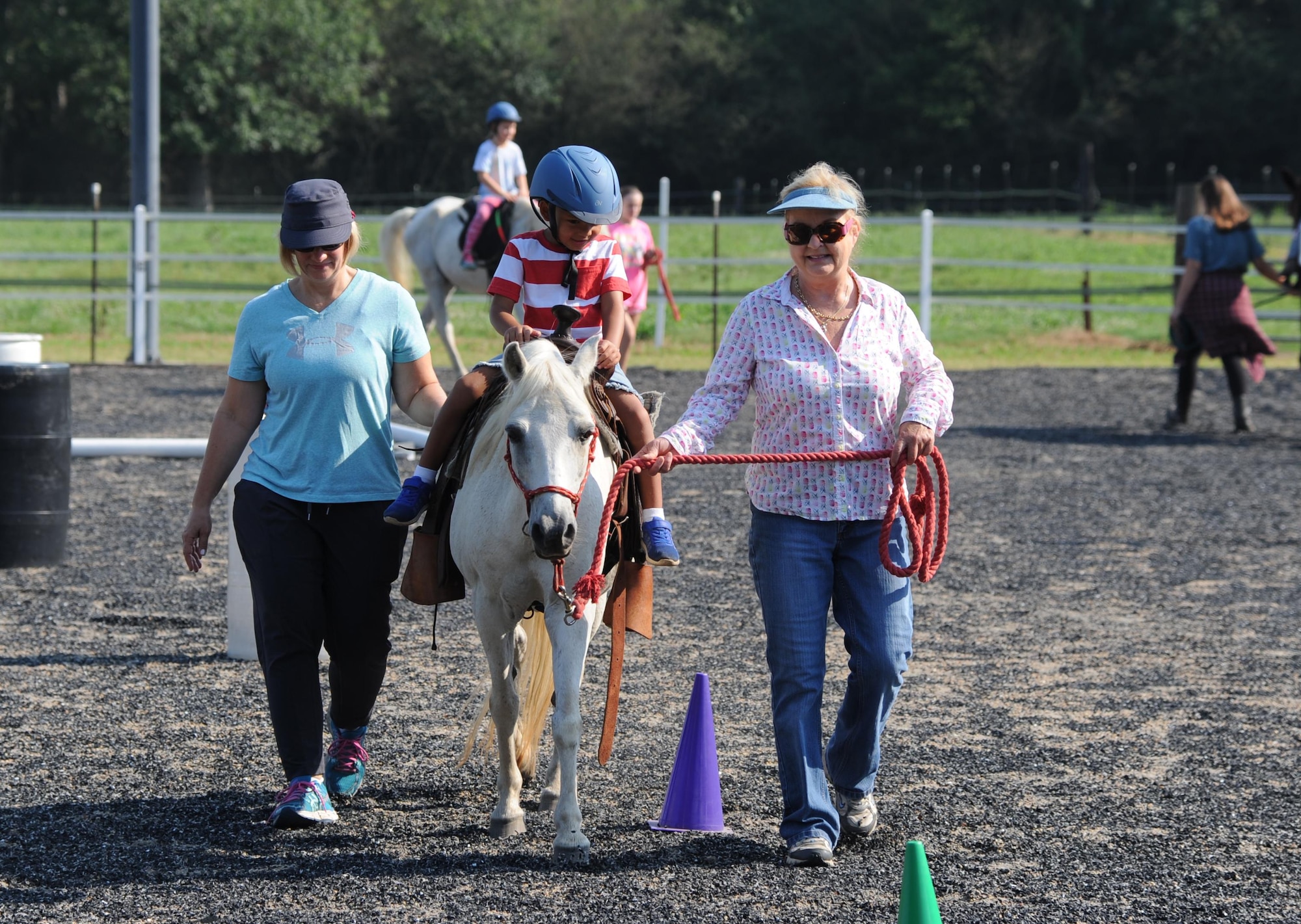 Avery, son of Lt. Col. Erin Knightner, 14th Medical Group Chief Nurse, rides a pony in the Riding to Improve Development, Esteem, Strength and Spirit arena July 21, 2017, in Caledonia, Mississippi. Parents were encouraged to walk beside their children so they could enjoy the therapy as well. Exceptional Family Member Program members from Columbus Air Force Base, Mississippi, were able to participate in a therapeutic horse riding session provided by the RIDES Program. (U.S. Air Force photo by Airman 1st Class Beaux Hebert)