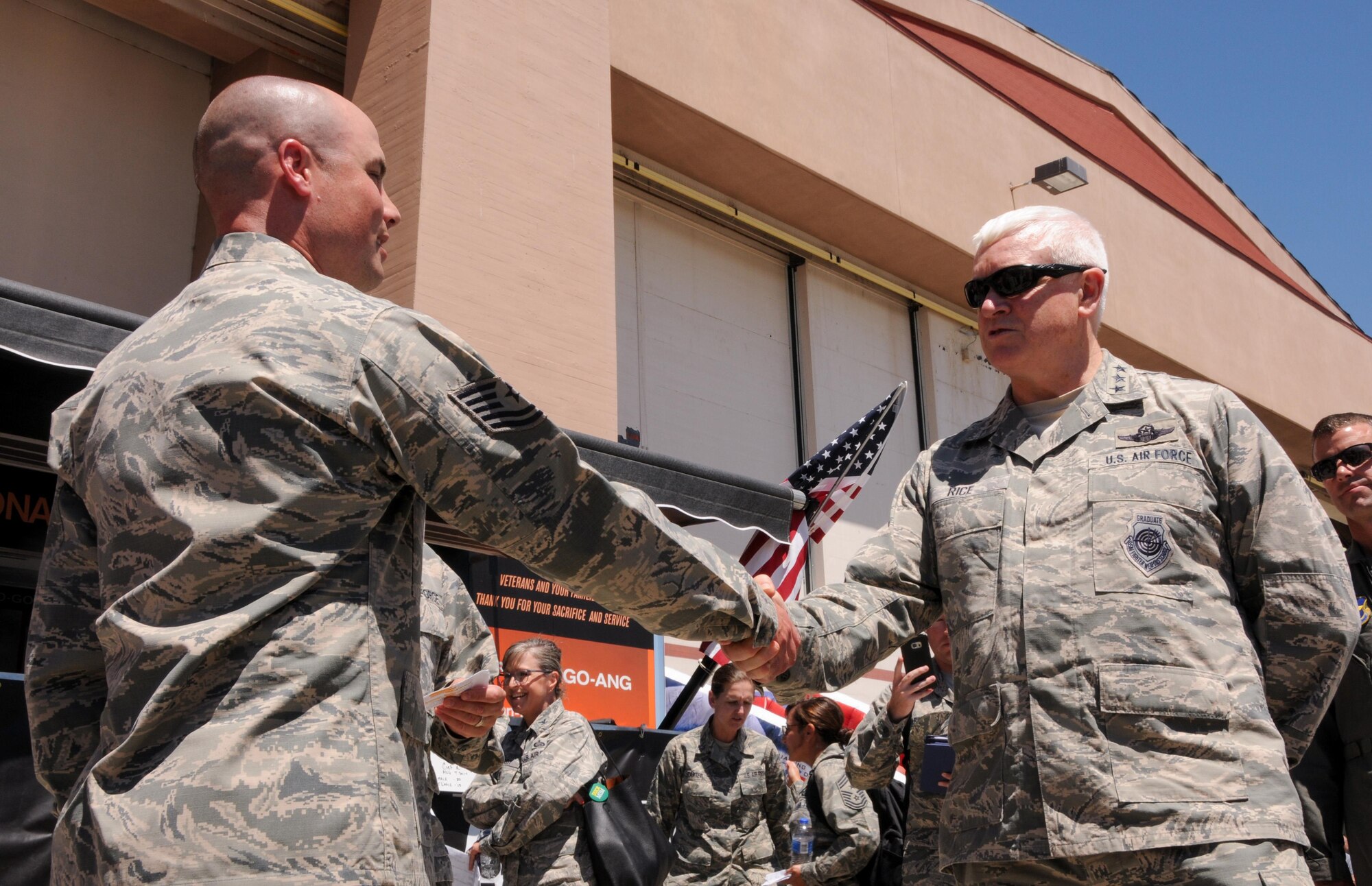 U.S. Air Force Lt. Gen. Scott Rice, director of the Air National Guard, coins Tech. Sgt. Darren Bennett, 173rd Fighter Wing recruiting and strength management, as he tours Kingsley Field during Sentry Eagle, July 22, 2017, at Kingsley Field in Klamath Falls, Oregon. The Sentry Eagle Exercise was conducted simultaneously with an open house event open to the public. (U.S. Air National Guard photo by Staff Sgt. Penny Snoozy)