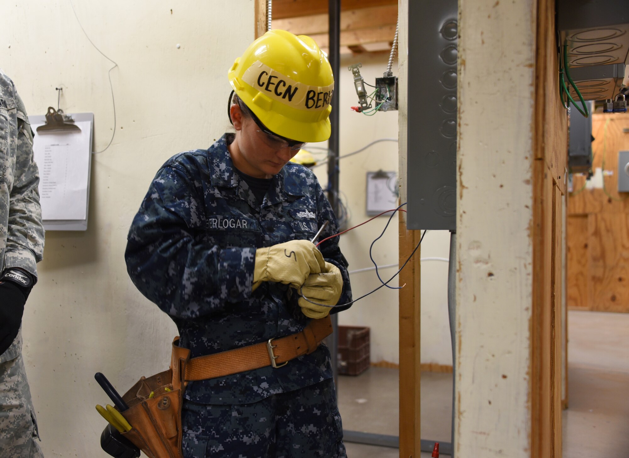 Seaman Kylie Berlogar, 366th Training Squadron electrical systems apprentice course student, checks the source of energy in a three-phase breaker at Sheppard Air Force Base, Texas. This course provides initial training for students to perform installation and maintenance duties of interior electrical systems. (U.S. Air Force photo/Liz H. Colunga)